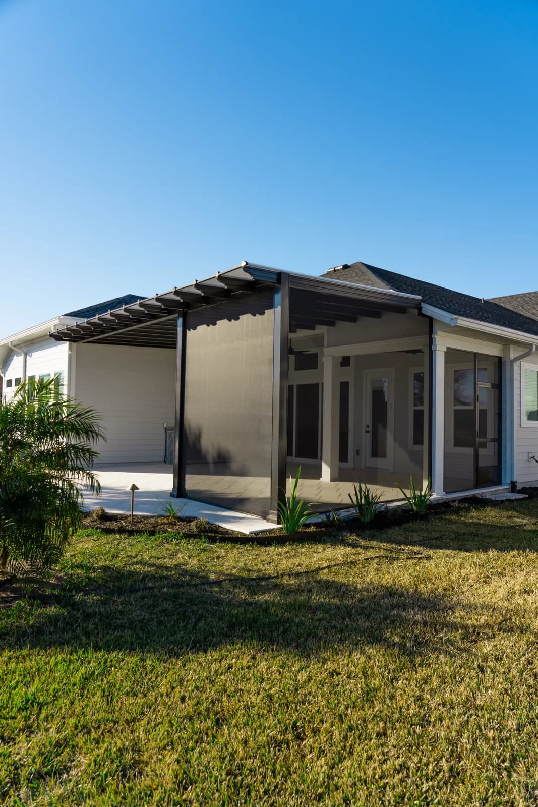 Finished screened lanai with a pergola-style front on a new-construction home