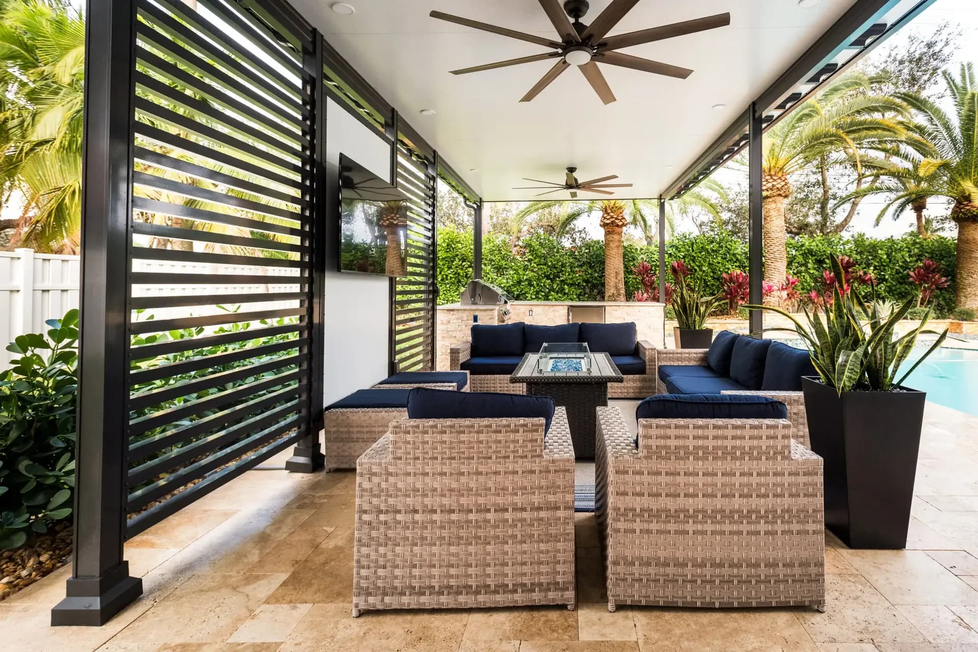 Covered poolside lounge with ceiling fans and privacy slats